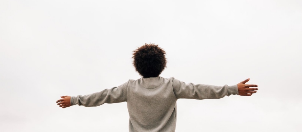 Back of a person with arms outstretched