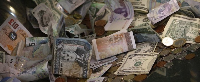 Lots of coins and paper money in a pile