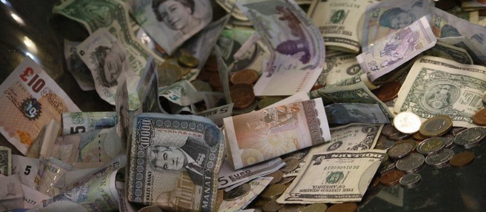 Lots of coins and paper money in a pile