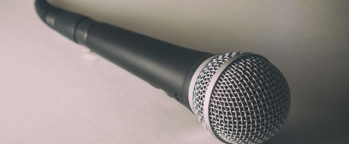 Microphone. Free stock photo of classic dynamic microphone on white background, shadows and shallow depth of field. Microphone lying on the white floo
