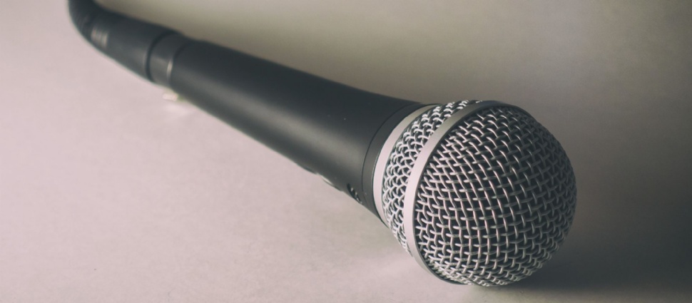Microphone. Free stock photo of classic dynamic microphone on white background, shadows and shallow depth of field. Microphone lying on the white floo